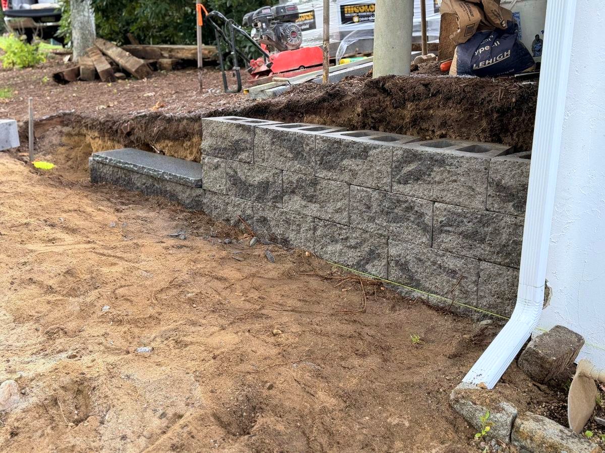 Excavated run with compacted base and the first courses set