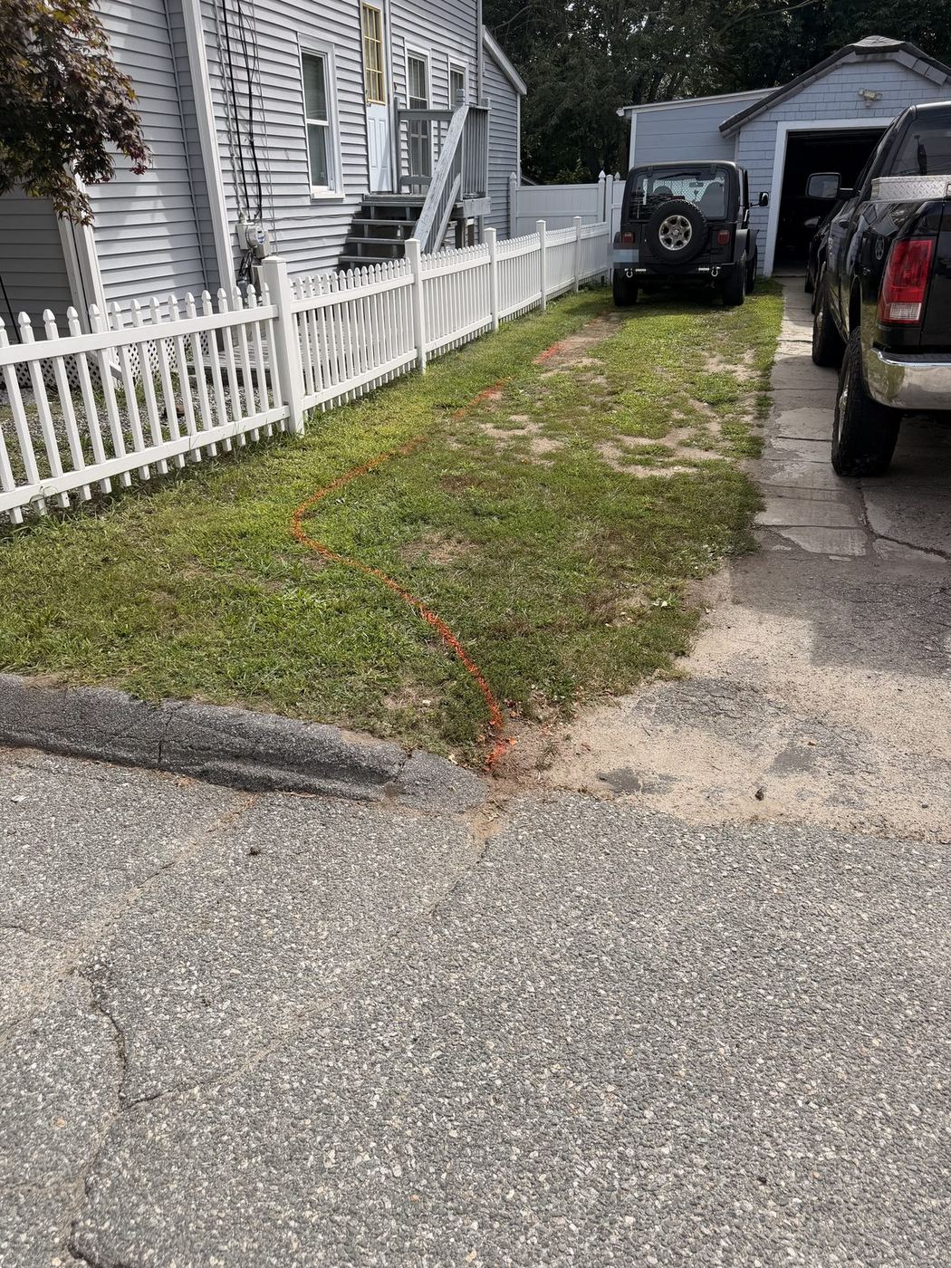 Marking paint running down to the curb where the driveway meets the street